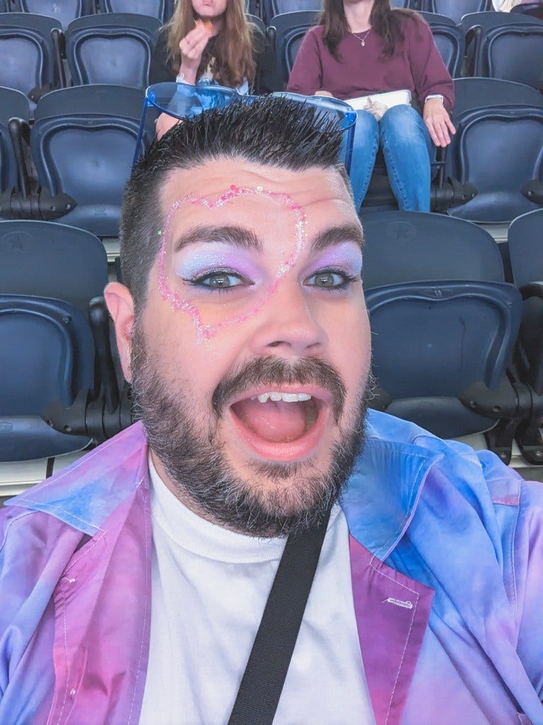 A photo of the writer with pastel eyeshadow and a heart made of glitter around his eye